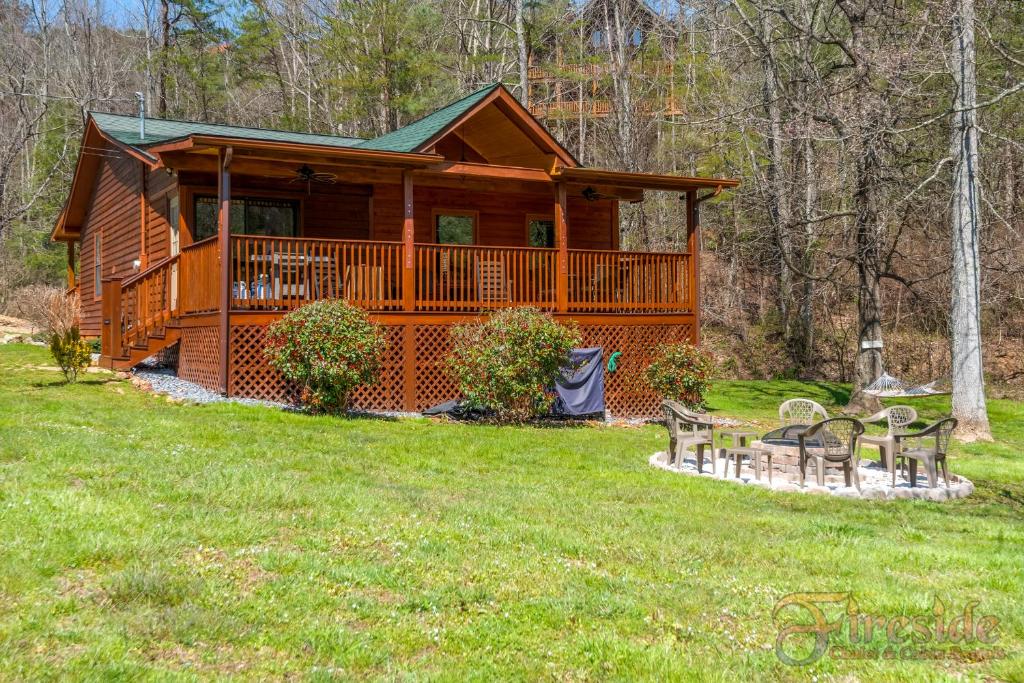 a log cabin with benches in front of it at Bear Run in Sevierville