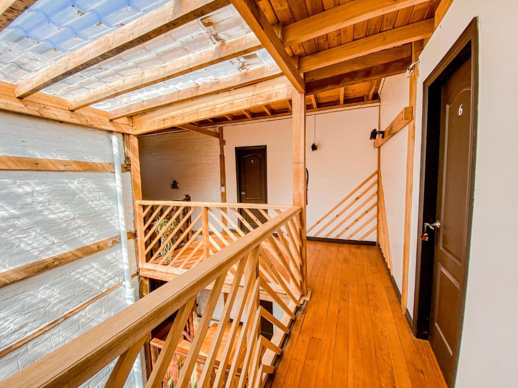 a wooden staircase in a room with wooden floors at Chuza Longa Home in Guamote