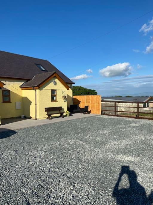 a shadow of a person taking a picture of a house at Quiet cottage, Ryan Anglesey in Holyhead