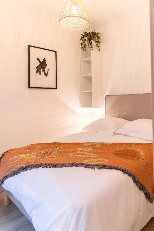 - une chambre avec un lit et une photo d'un plan mural dans l'établissement Thomas Price Appart, à Narbonne