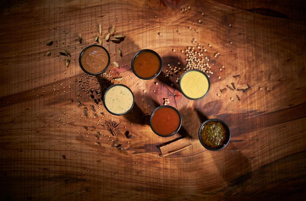 a group of different colored paints on a wooden table at PortoBay Blue Ocean in Albufeira