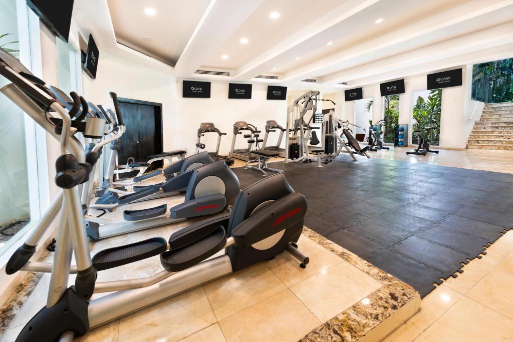 a gym with treadmills and elliptical machines at Grand Oasis Tulum Riviera - All Inclusive in Akumal