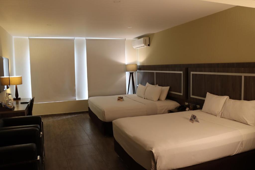 Postel nebo postele na pokoji v ubytování Rado Hotel - Quintanas