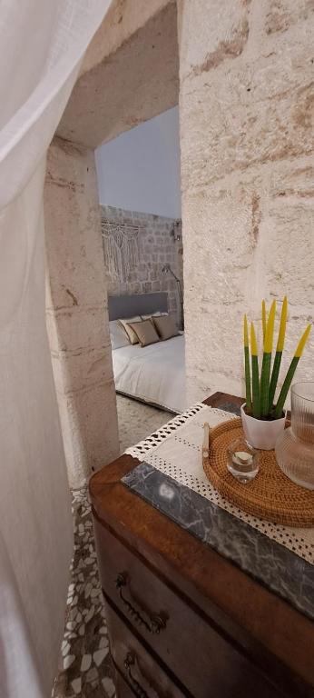 a bedroom with a bed and a dresser with a bowl of flowers at Casa dolce casa in Casamassima