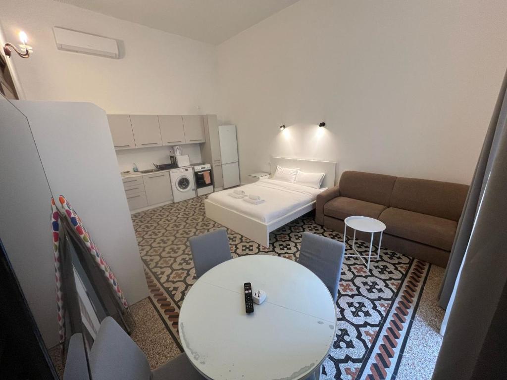 a small living room with a couch and a table at The Old Mint Residence 4 in Valletta