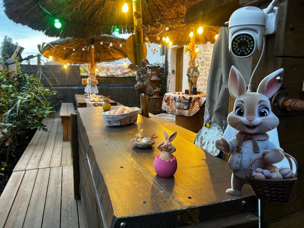 a table with a figurine of a rabbit on it at Les Chambres de Paulette à Theme LA JUNGLE ROOM in Sainte-Marie-la-Mer