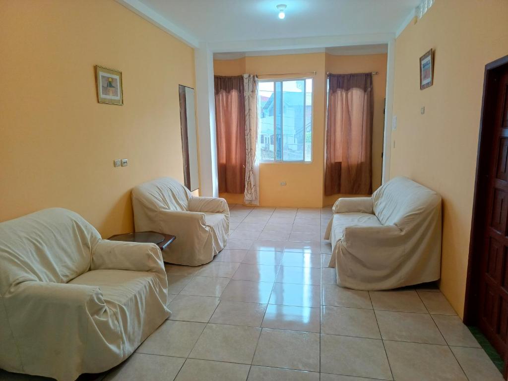 a living room with two chairs and a couch at Lobito in Puerto Baquerizo Moreno