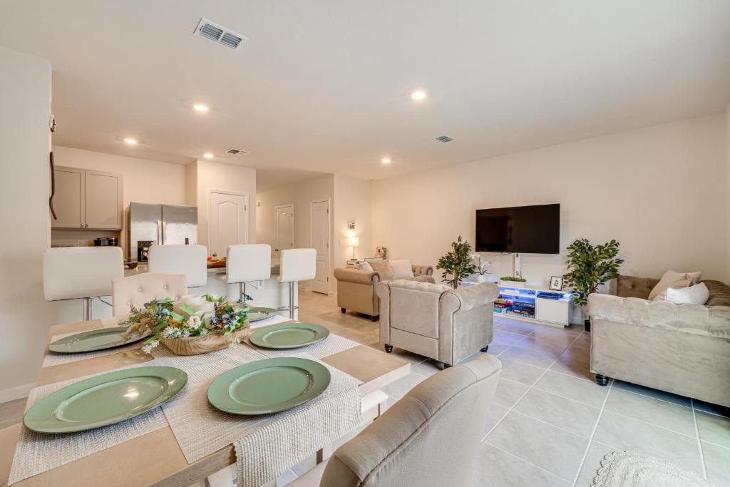 a living room with a table with green plates on it at Davenport Home w/ Pool Access & Patio! in Davenport