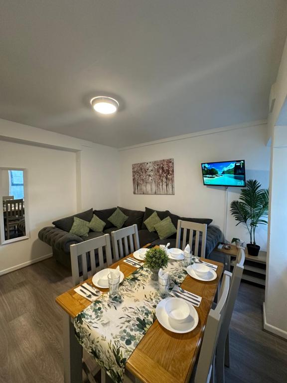 a dining room with a table and a couch at Mary Street Apartment in Galway
