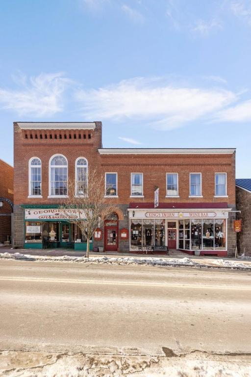 a large brick building on the side of a street at Leesburg Colonial Inn in Leesburg