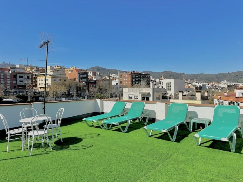 a group of chairs and tables on a roof at Casa independiente-Garden-Views-2 bedrooms in Barcelona