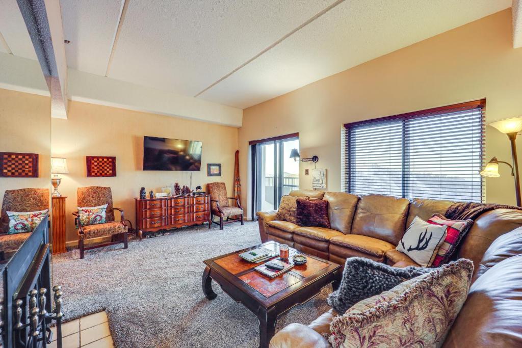 a living room with a couch and a coffee table at Mountain Views and Pool Access Sugar Mountain Condo in Sugar Mountain