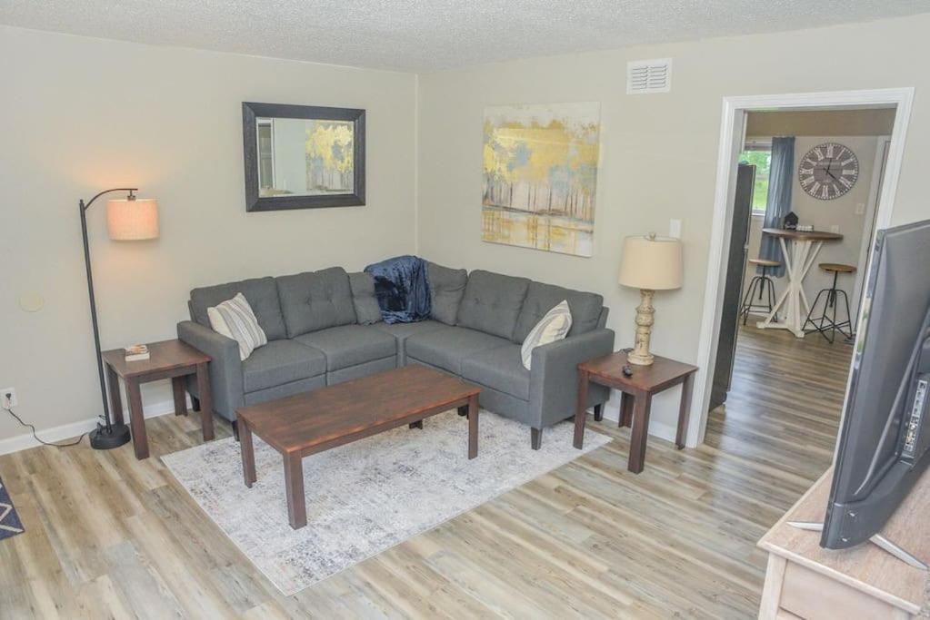 a living room with a couch and a tv at Townhomes Near the Bay - #2 in Grand Bay