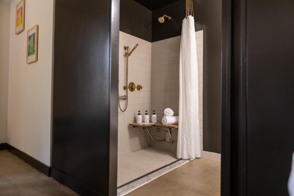 a bathroom with a shower with a shower curtain at STILE Downtown Los Angeles by Kasa in Los Angeles