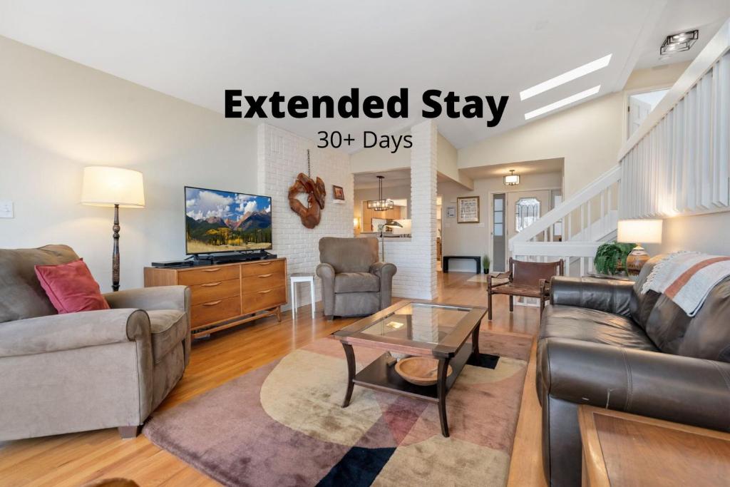 an extended stay living room with a couch and a table at Mid-Century Mod Retreat with Lakefront Trails, Quiet in Fort Collins