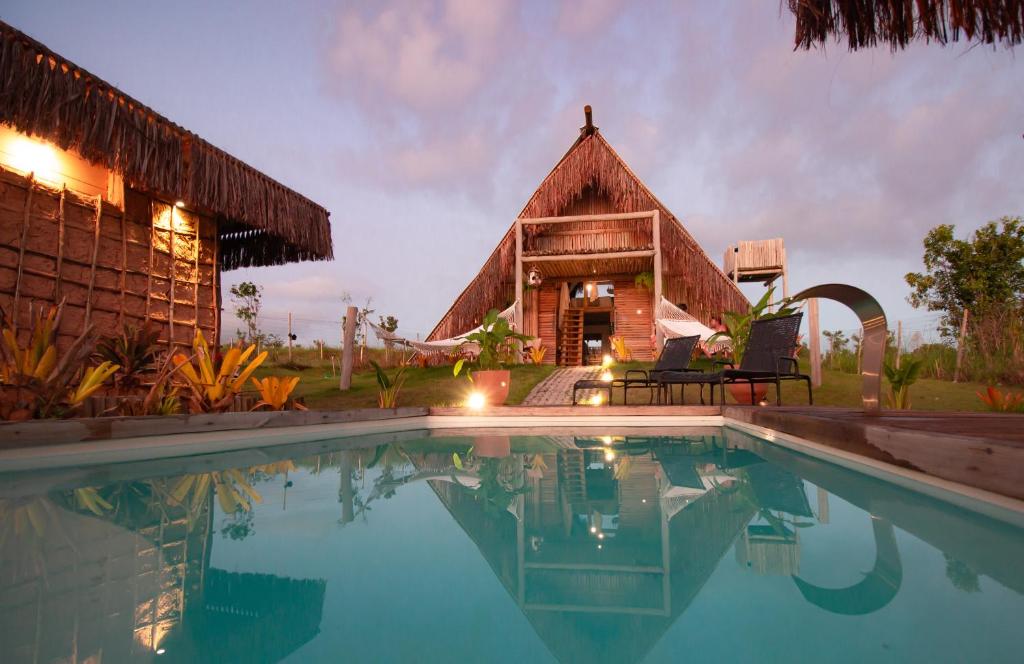 a resort with a pool in front of a building at Cabana Serena in Corumbau