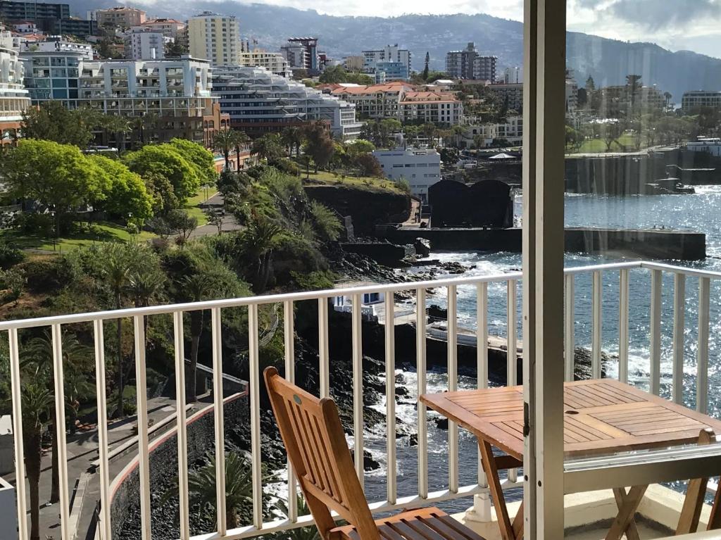 a balcony with a table and a view of the water at Апартаменты 303 - Studio in Funchal