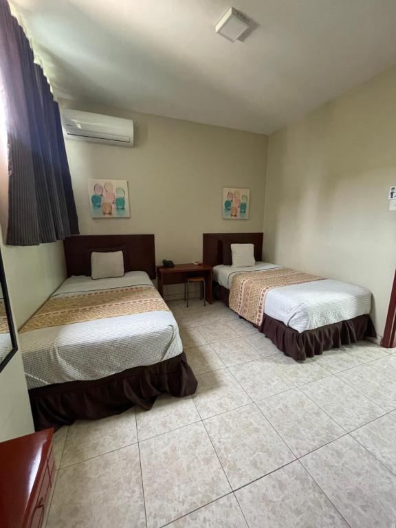 Postel nebo postele na pokoji v ubytování Hotel Air Suites