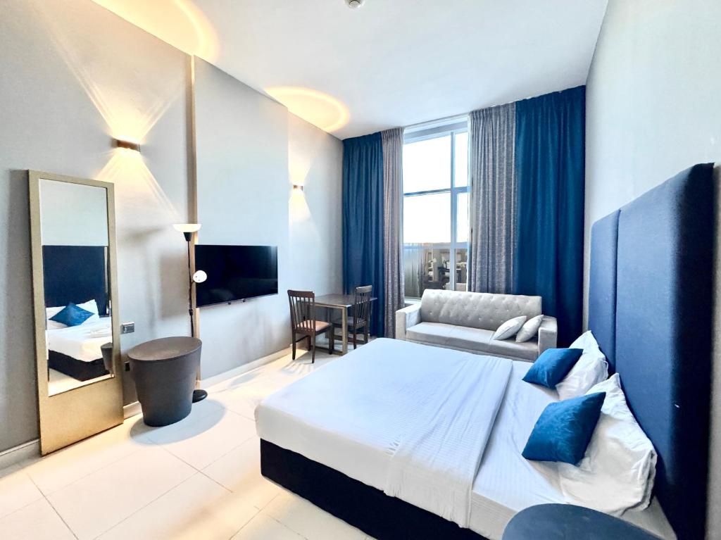 a hotel room with a bed and a mirror at Al Manara Classic Luxe Studio in Dubai