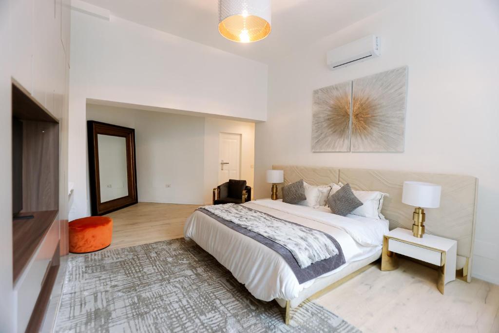a white bedroom with a large bed and a mirror at Duomo Florence - Esclusive Luxury in Florence