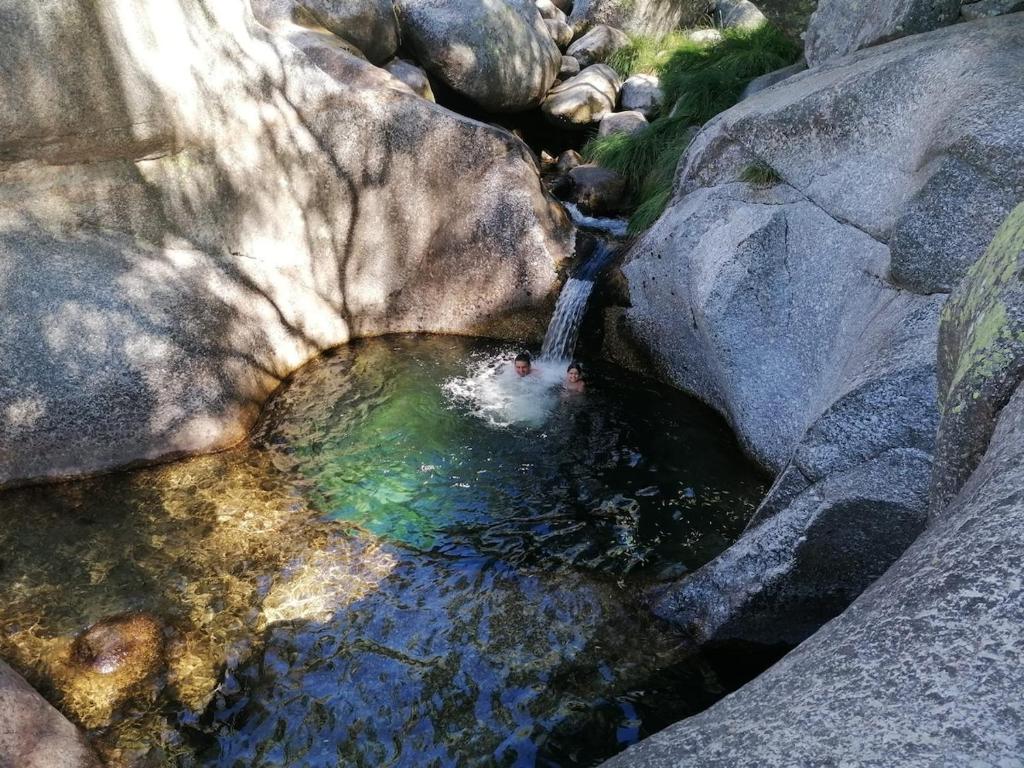 an aerial view of a waterfall in a pool of water at Piscinas, Serra da Estrela AL in Bouça