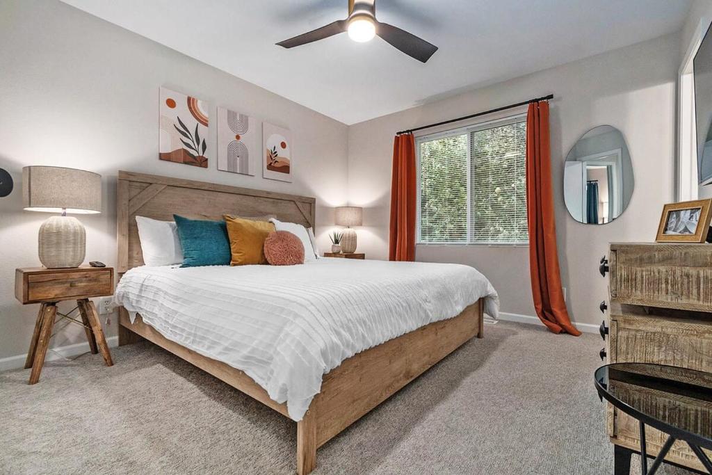 a bedroom with a large bed and a window at Elegant Escape-Fenced Yard BBQ & Cozy Fire Pit in Omaha