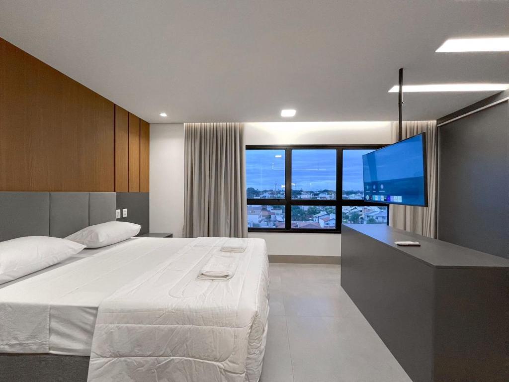 En eller flere senge i et værelse på Flat Espaçoso no 8º Andar do Prime