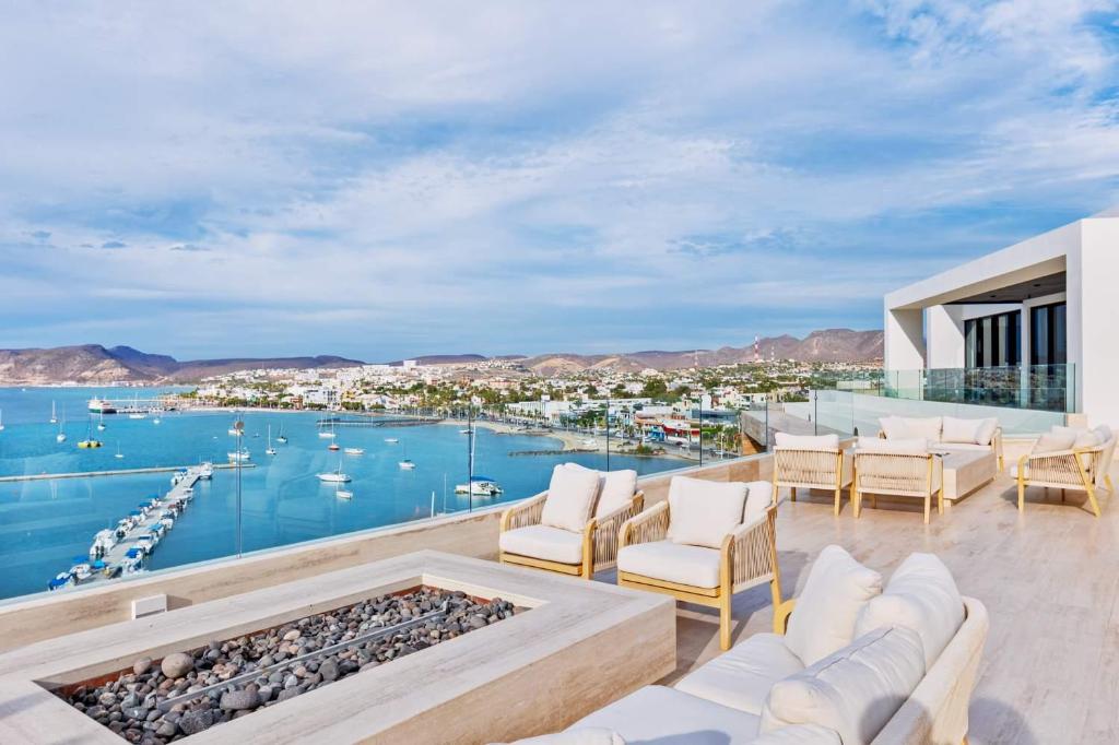 a living room with a view of the water at 2 Bedroom Residence with Terrace & Grill Live Aqua La Paz in La Paz