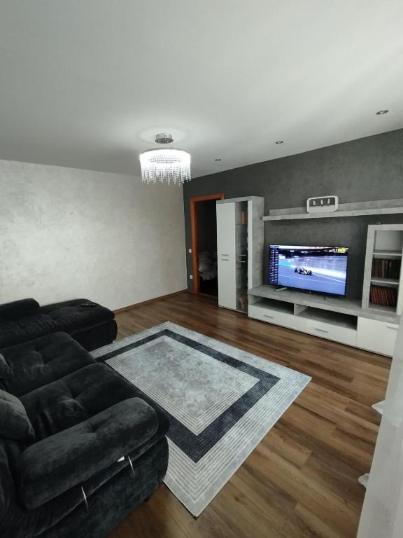 a living room with a couch and a flat screen tv at Апартаменти біля автостанції Кравчука, 40 in Lutsk