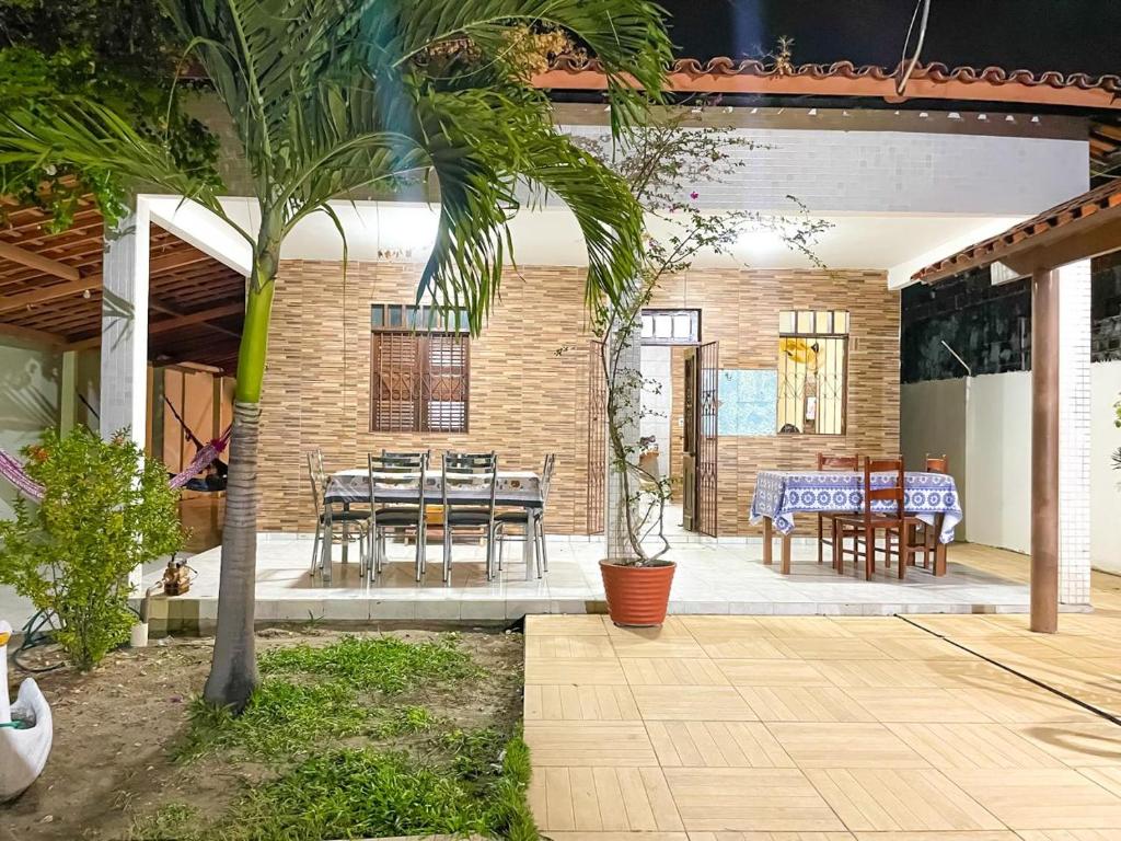 a patio with a table and chairs and a palm tree at Lucena House in Lucena