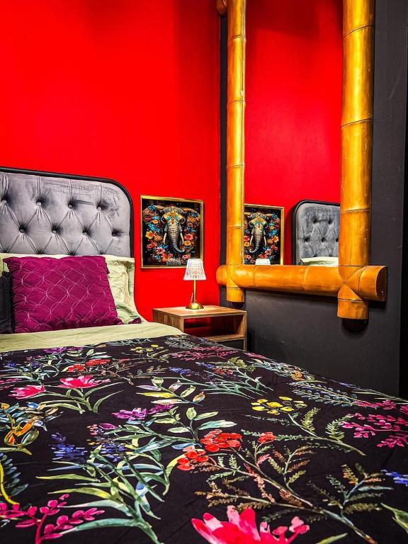 a bedroom with a bed and a red wall at ORHO HOTEL BOUTIQUE PANAMA Tocumen Airport free shuttle highway round trip 15 minuts in Tocumen