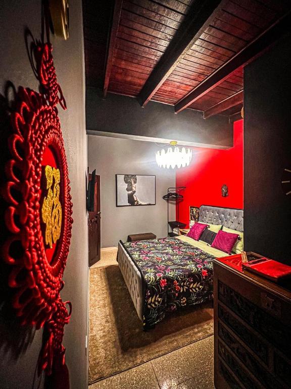 a bedroom with a bed and a red wall at ORHO HOTEL BOUTIQUE PANAMA Tocumen Airport free shuttle highway round trip 15 minuts in Tocumen