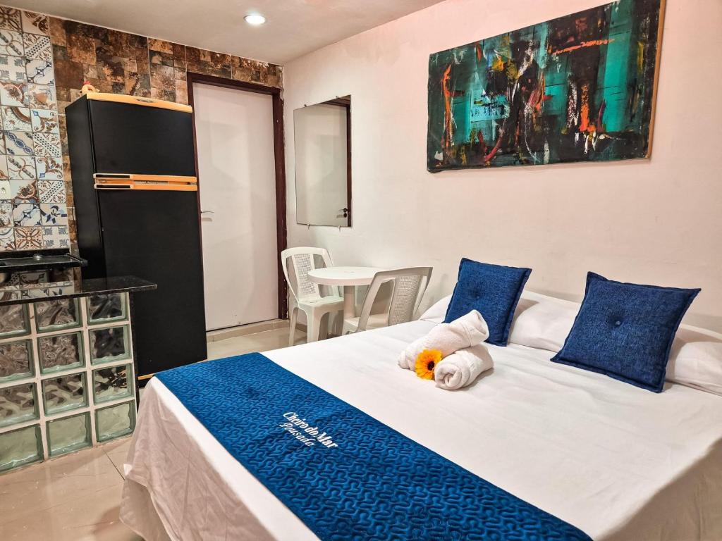 a bedroom with a bed with a teddy bear on it at Pousada Cheiro do Mar in Porto De Galinhas