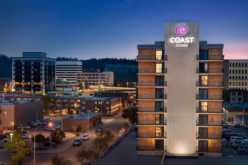 a view of a building with a guest sign on it at Coast Prince George Hotel in Prince George