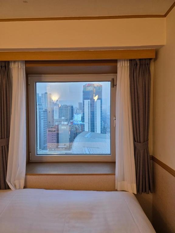 Postel nebo postele na pokoji v ubytování Toyoko Inn Busan Station No.1