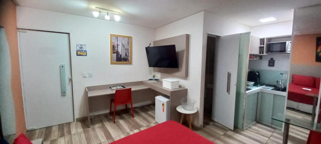 a small room with a desk and a tv in it at Lofts portal 225 unid 01 in Recife