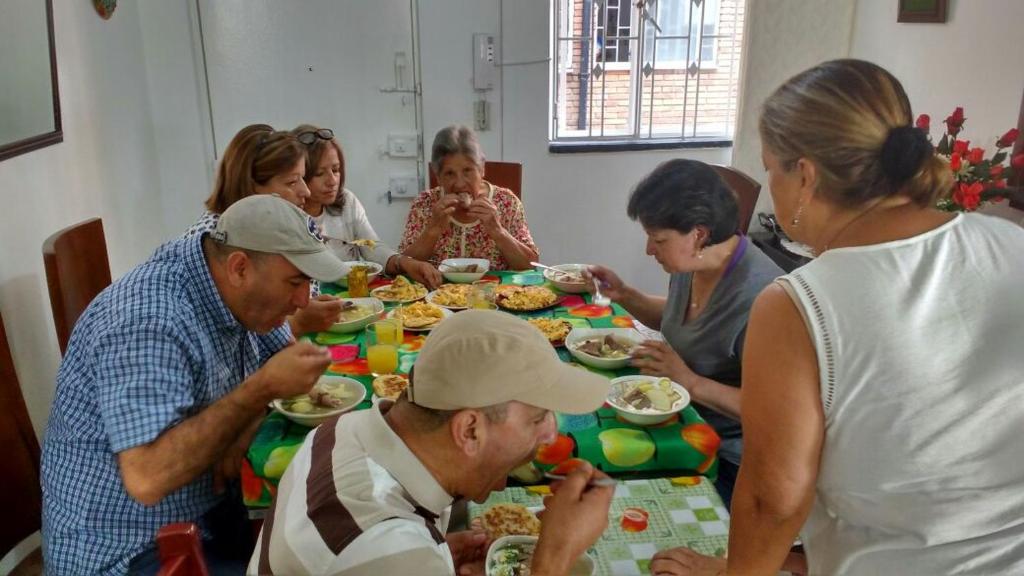 a group of people sitting around a table eating food at Hotel in Villa de Leyva