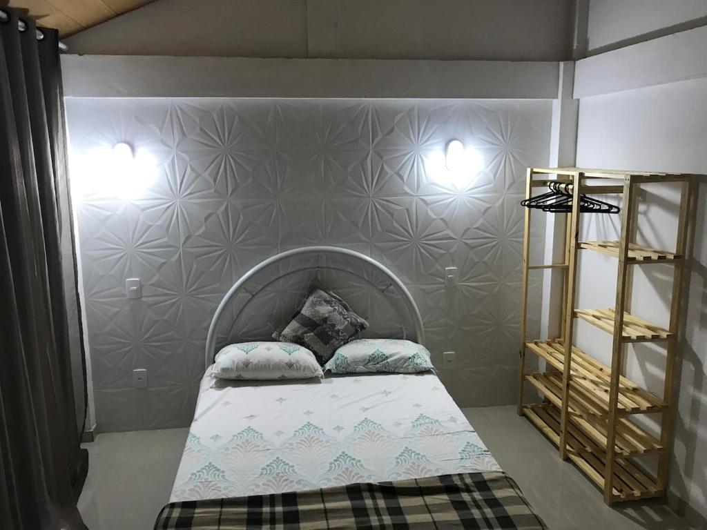 Un pat sau paturi într-o cameră la Casa em Buzios
