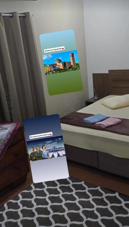a box sitting on a floor next to a bed at Casinha feliz in Guaratinguetá