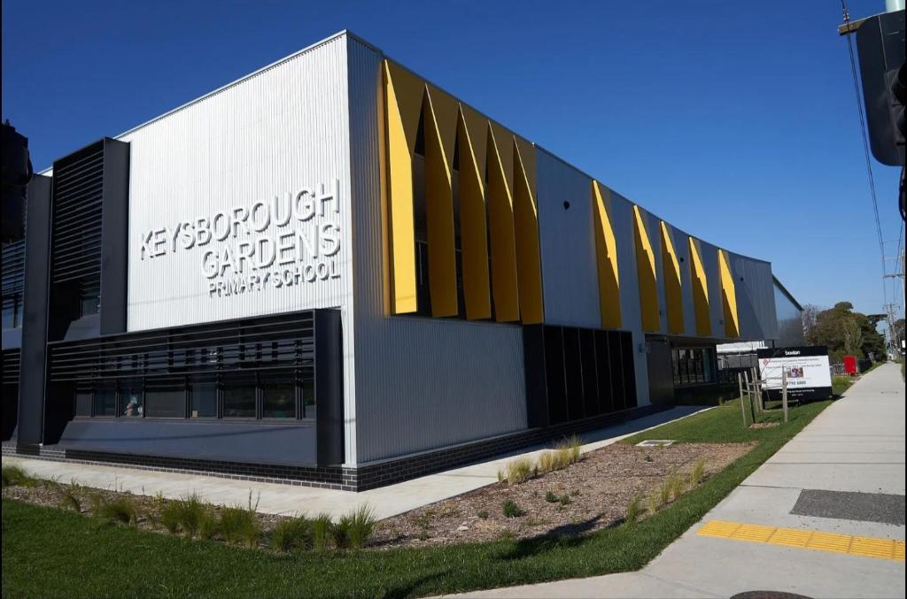a building with a sign on the side of it at Classy Spaces Keysborough - New 2 Storey Townhouse in Keysborough