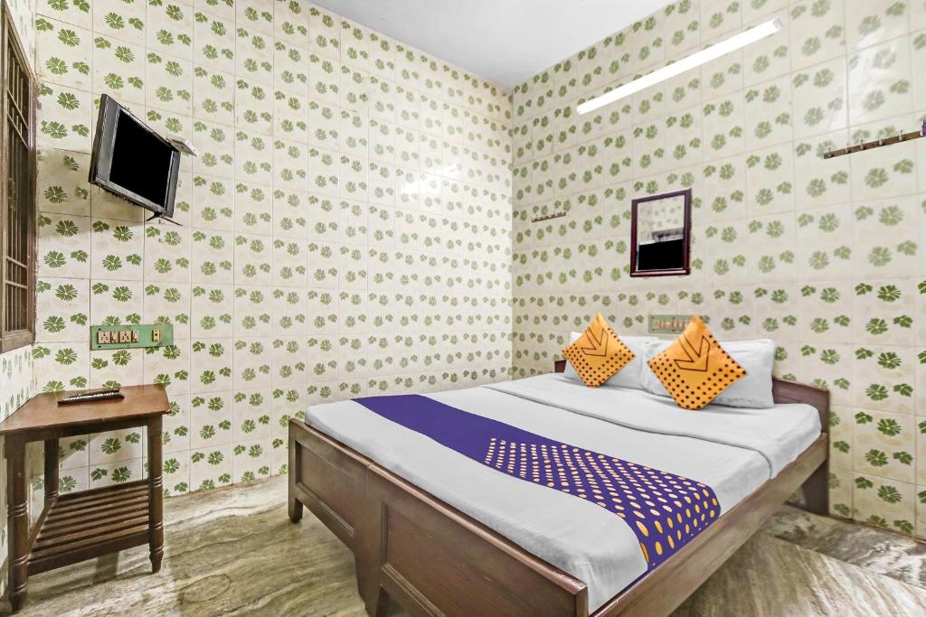Postel nebo postele na pokoji v ubytování Hotel O Ams Annex