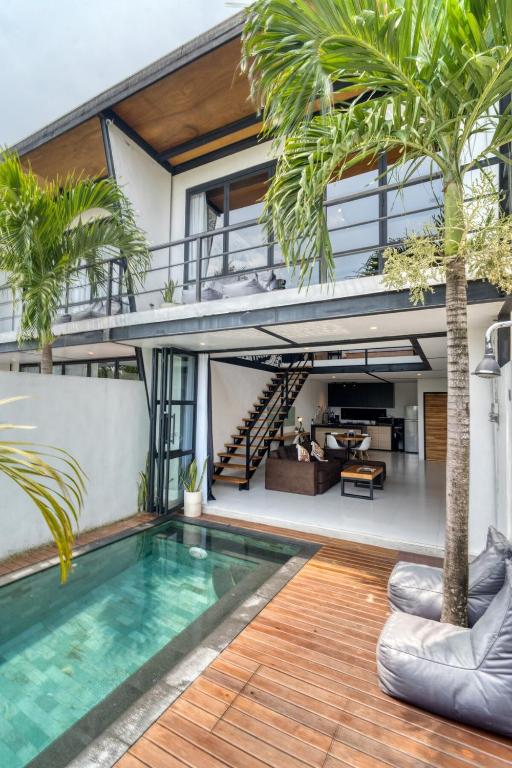 an open house with a swimming pool and a house at Echo Haven A2 1BR Loft In Canggu in Canggu