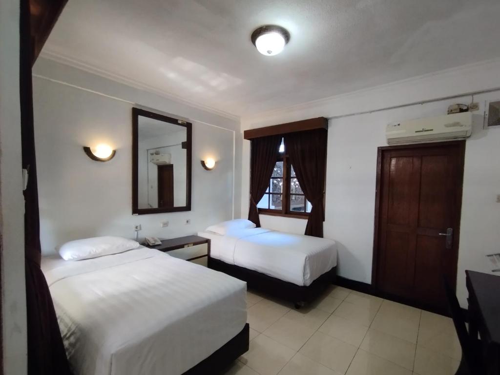 Postel nebo postele na pokoji v ubytování Hotel Bahtera PT.Pelni