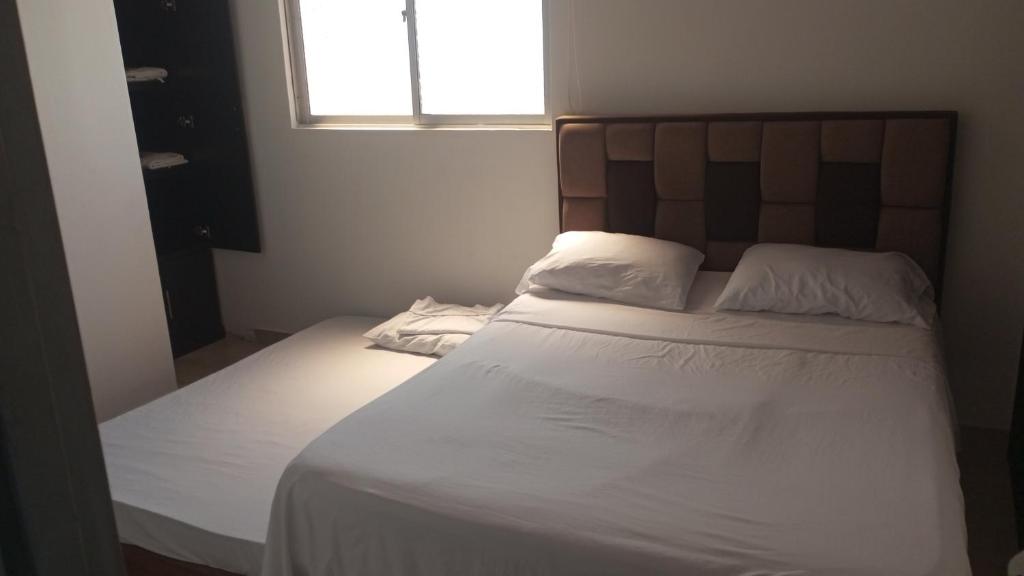 Postel nebo postele na pokoji v ubytování Hotel Palmari