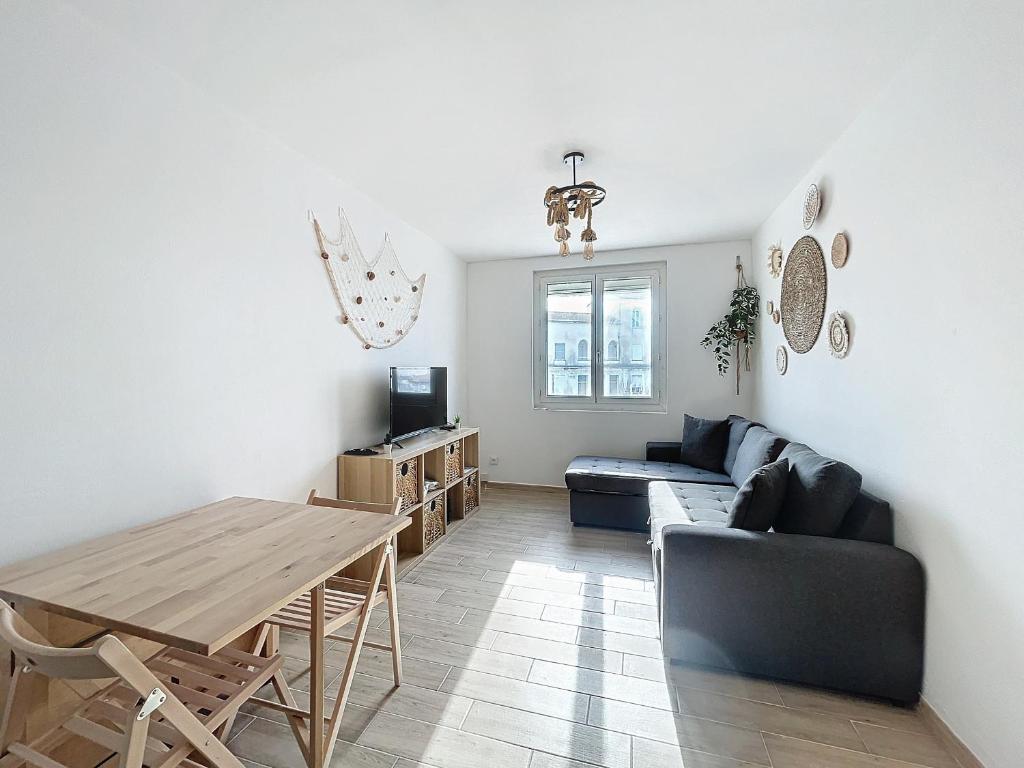 un salon avec une table et un canapé dans l'établissement Appartement pour 4, rénové, climatisé, aux Saintes-Maries-de-la-Mer - FR-1-475-152, à Saintes-Maries-de-la-Mer