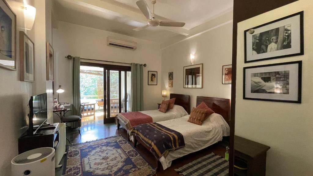 a bedroom with a bed and a television in it at Zaza Stay in New Delhi