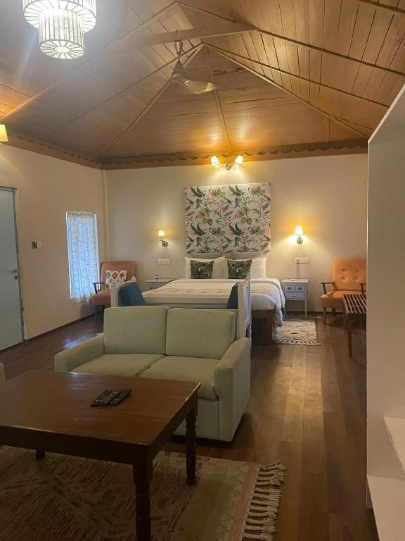 a living room with a bed and a couch at Munjoh Ocean Resort - Private Beachfront Luxury Retreat in Havelock in Havelock Island