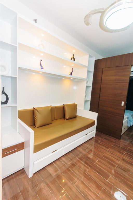 a couch in a room with white walls and wooden floors at City Chill Spot Where Style Meets Smiles Swim Gym Park 1765 in Manila