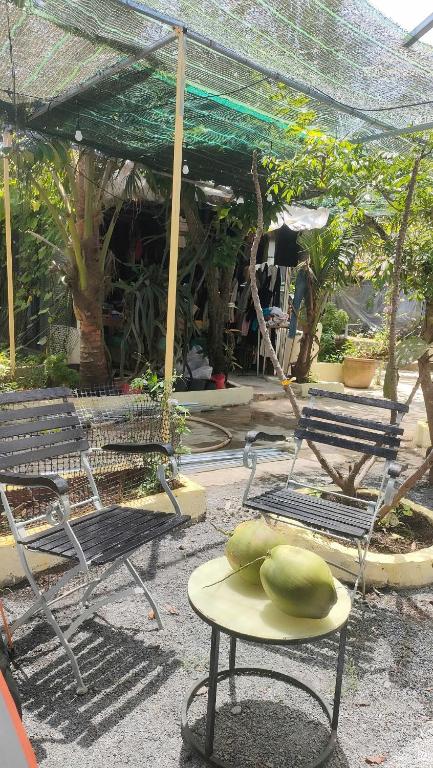 a table with two melons on top of it at Happy Farm Homestay in Ấp Long Ðại