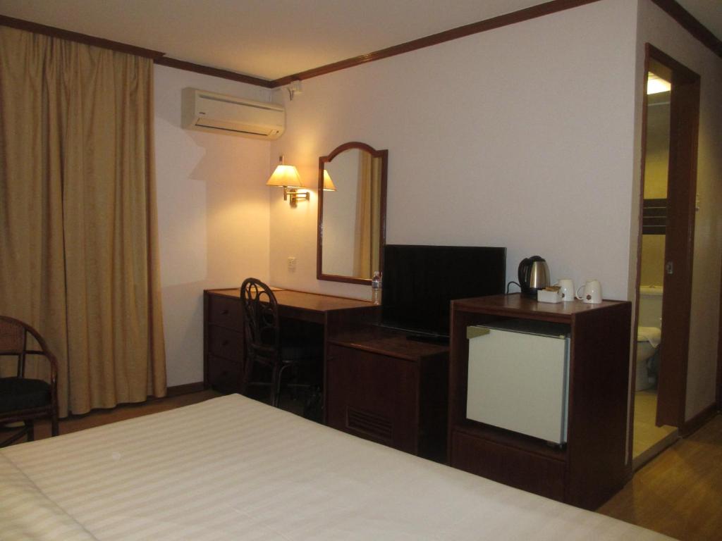 Postel nebo postele na pokoji v ubytování Sanbay Hotel